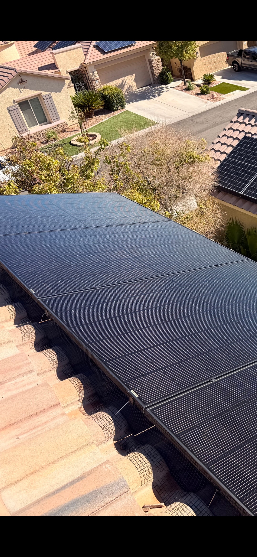 Completed bird proofing installation with wire mesh barrier on residential solar panels