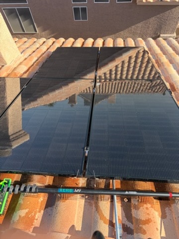 Clean solar panels on tile roof after professional cleaning service