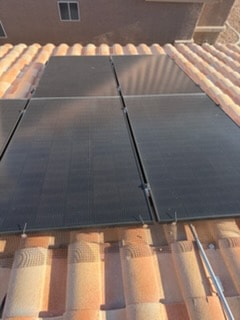 Dirty solar panels on tile roof before professional cleaning