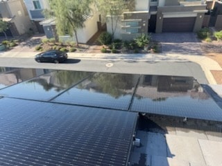 Clean solar panels reflecting neighborhood after professional cleaning