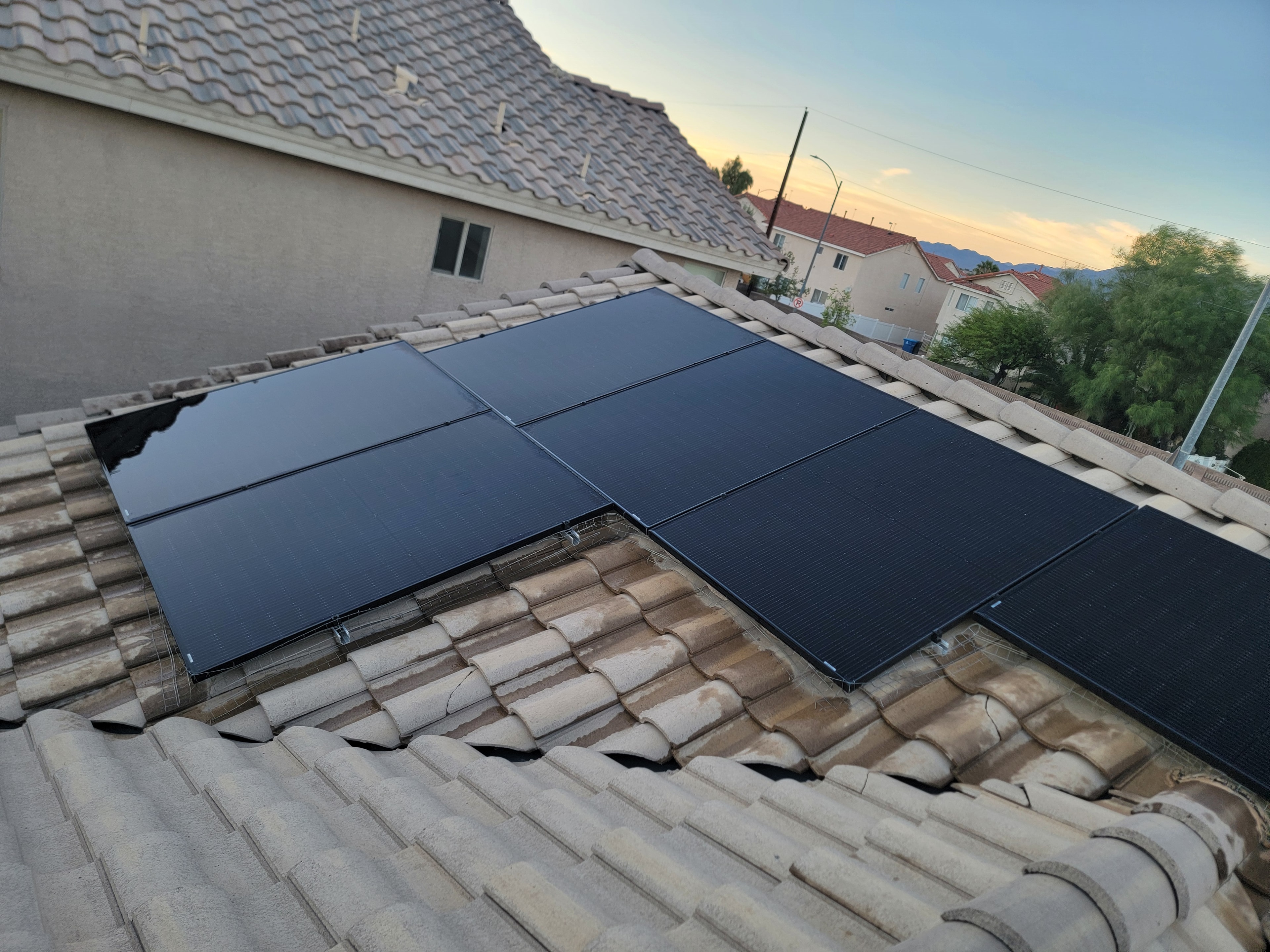 Clean solar panels gleaming at sunset after professional cleaning service